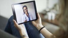 Patient observing physician on iPad during telehealth