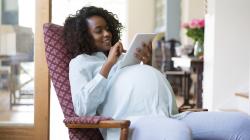 Pregnant person using tablet