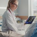 Healthcare worker showing tablet to patient