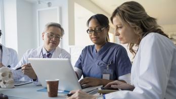 doctors looking at a computer