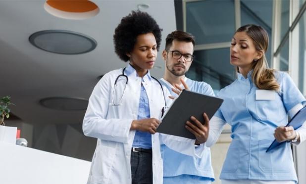 Healthcare workers looking at clipboard