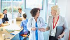 Doctor talking to businessperson at meeting