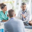 A multidisciplinary team of hospital staff holding a meeting