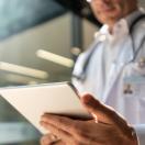 Doctor looking at a patient chart on a digital tablet 