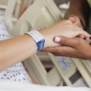 Patient holding healthcare worker's hand