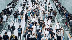 Crowd of commuters wearing masks