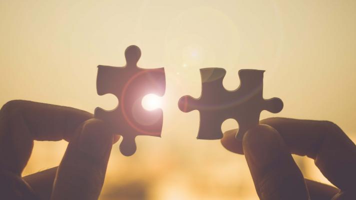 Puzzle pieces fitting together, showing connection and success