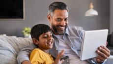 Parent and child looking at tablet