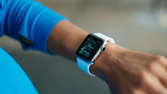 A wrist with a smartwatch on it