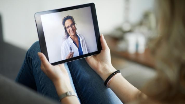 clinician on a tablet