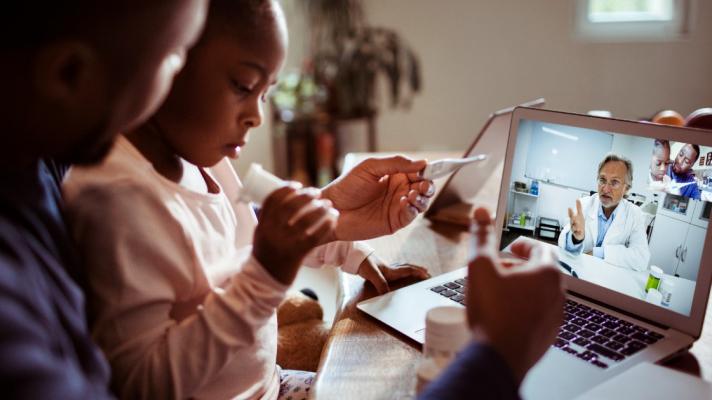 Adult and child laptop telehealth visit