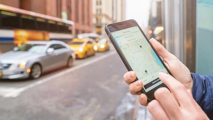 Person using rideshare app on smartphone