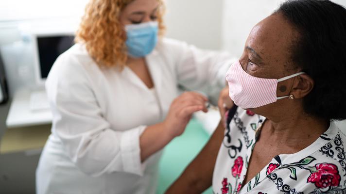 Nurse administers COVID-19 vaccine.