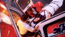 Overhead view of paramedics putting a patient on a stretcher into an ambulance