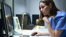 Health professional at computer screen